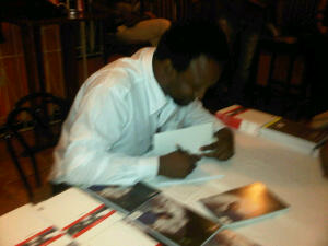 Ruel Johnson signing a copy of Fictions